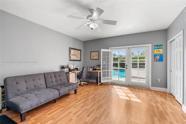 living room with ceiling fan, french doors, and light wood-type flooring