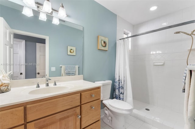 bathroom featuring toilet, tile patterned floors, vanity, and curtained shower