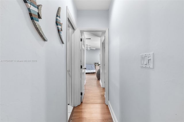 hallway with hardwood / wood-style floors