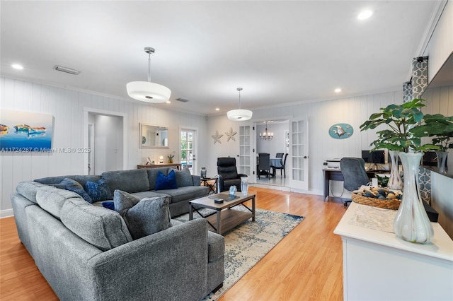 living room featuring ornamental molding and light hardwood / wood-style floors