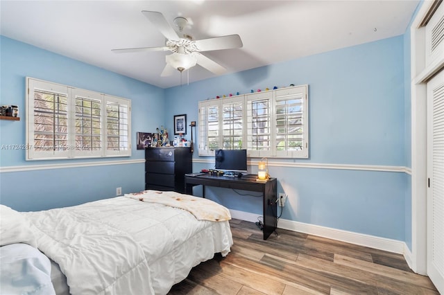 bedroom with ceiling fan, hardwood / wood-style floors, and a closet