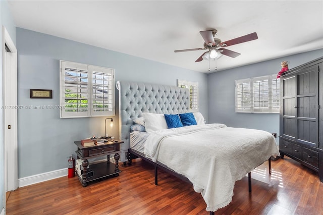 bedroom with dark wood-type flooring, ceiling fan, and multiple windows