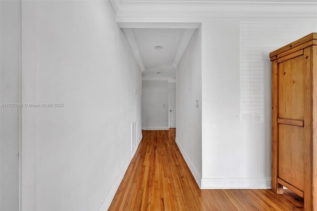 corridor featuring ornamental molding and light wood-type flooring