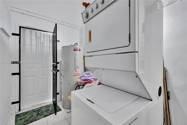 laundry room featuring electric water heater, stacked washer and clothes dryer, and light tile patterned flooring