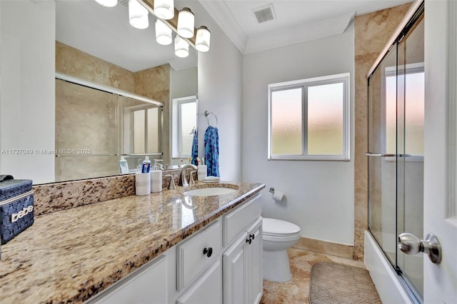 full bathroom with toilet, combined bath / shower with glass door, tile patterned flooring, crown molding, and vanity