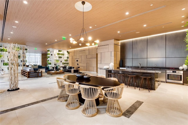 dining area with an inviting chandelier and wooden ceiling