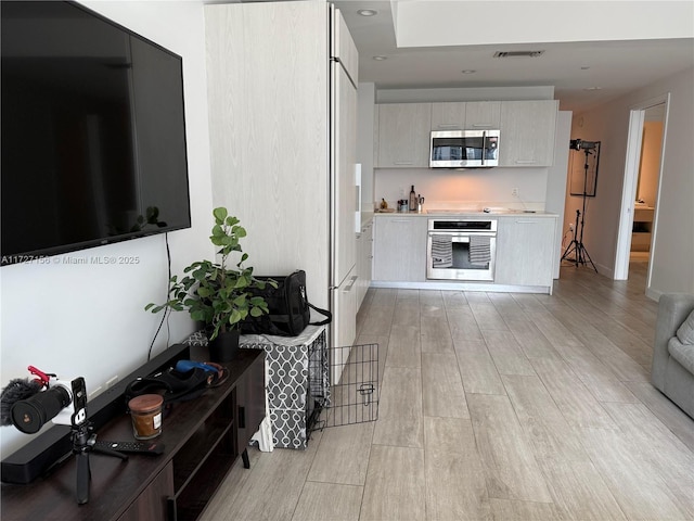 kitchen with white cabinets and appliances with stainless steel finishes