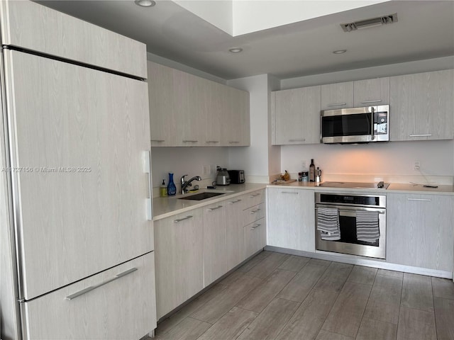 kitchen featuring sink, light brown cabinets, and stainless steel appliances