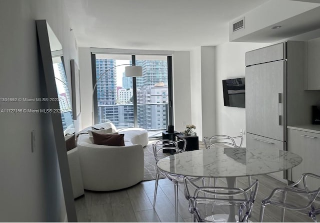 living room featuring floor to ceiling windows and hardwood / wood-style flooring