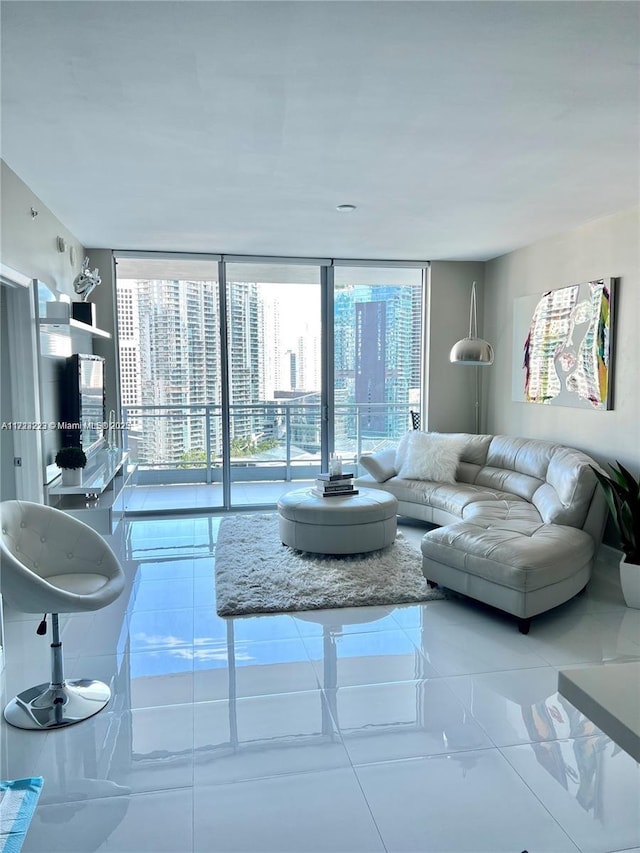 living room with floor to ceiling windows, plenty of natural light, and tile patterned flooring