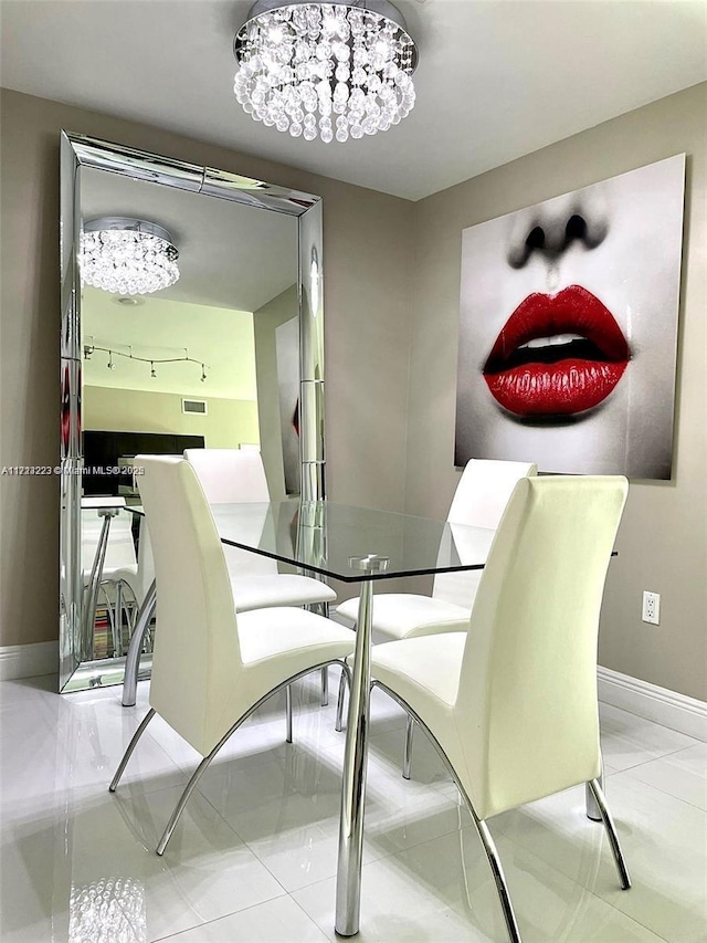 tiled dining area with a notable chandelier