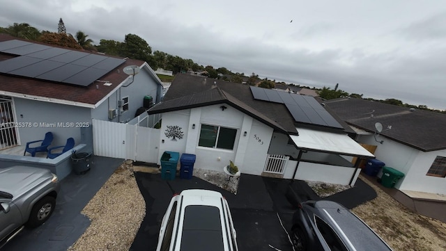 view of front facade featuring solar panels