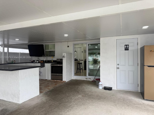 kitchen featuring refrigerator and stainless steel electric range oven