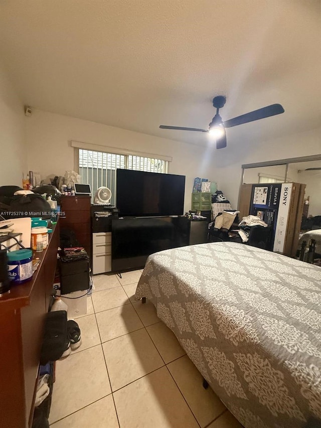 bedroom with ceiling fan and light tile patterned floors