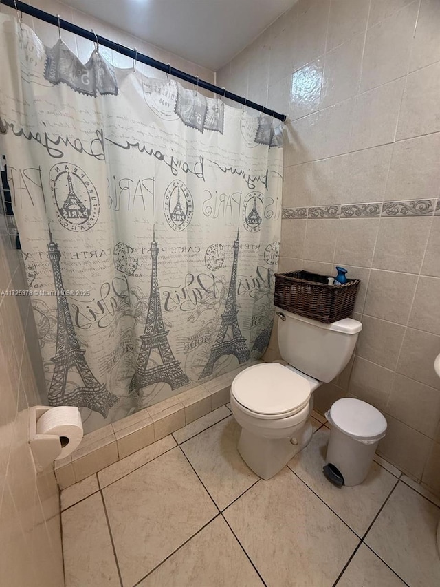 bathroom featuring tile walls, toilet, walk in shower, and tile patterned flooring