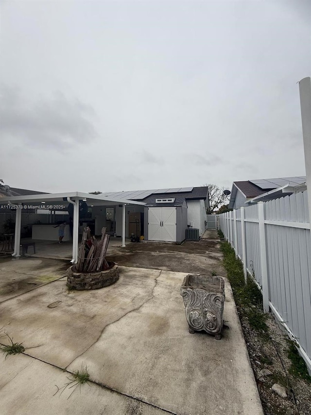 view of home's exterior with a shed, cooling unit, and a carport