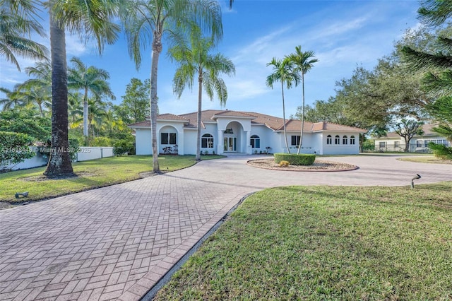 mediterranean / spanish-style house featuring a front lawn