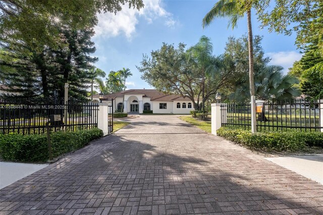 mediterranean / spanish home featuring a front lawn