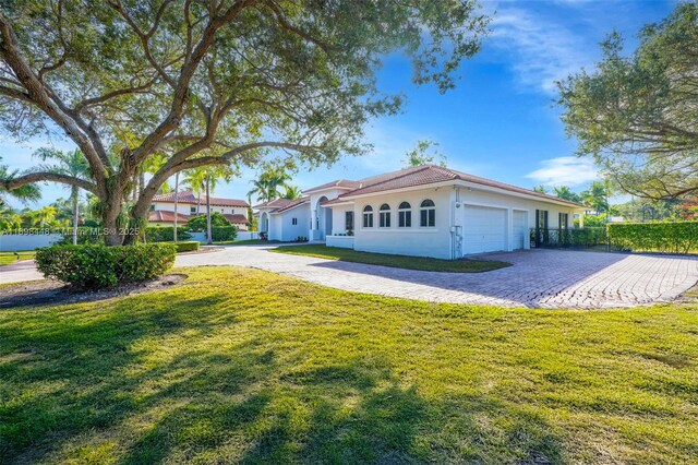 mediterranean / spanish home with a front yard