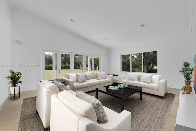 living room with high vaulted ceiling, recessed lighting, and plenty of natural light