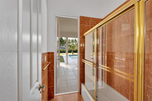 doorway to outside with tile patterned flooring, french doors, and tile walls