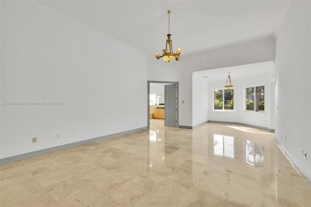 spare room featuring an inviting chandelier, baseboards, marble finish floor, and crown molding