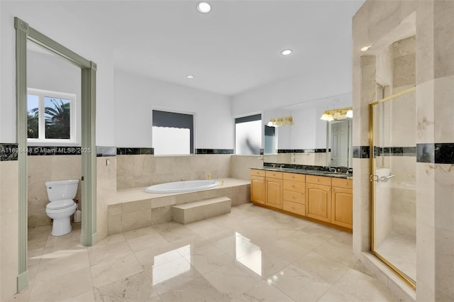 full bath featuring double vanity, toilet, a garden tub, a shower stall, and tile walls