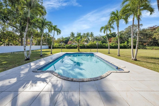 view of pool with a patio area, fence, a fenced in pool, and a yard