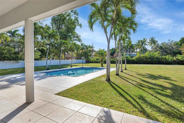 view of pool with a fenced in pool, a patio area, a lawn, and fence