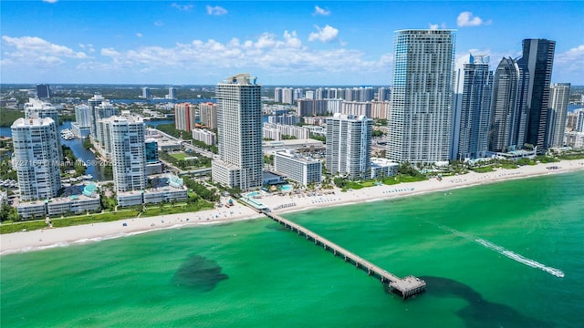 birds eye view of property featuring a beach view and a water view