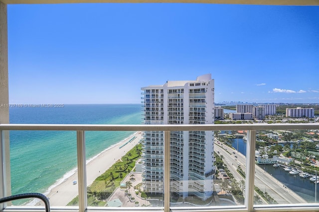 balcony featuring a water view and a view of the beach