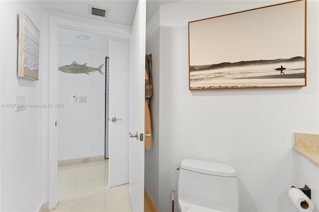 bathroom featuring vanity, toilet, and tile patterned flooring