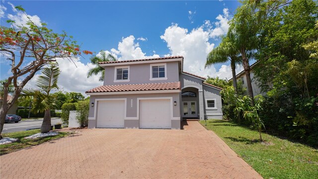 mediterranean / spanish-style house featuring a garage and french doors