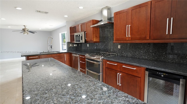 kitchen featuring wine cooler, sink, dark stone countertops, appliances with stainless steel finishes, and wall chimney range hood