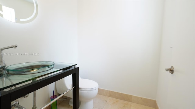 bathroom with tile patterned flooring, vanity, and toilet