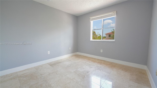 unfurnished room with a textured ceiling