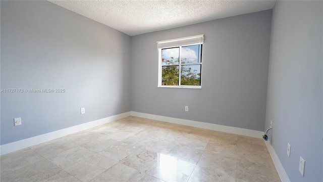 spare room with a textured ceiling