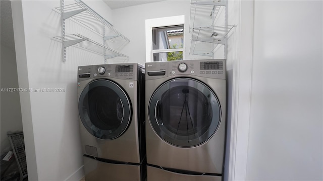 clothes washing area featuring washer and clothes dryer