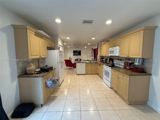 kitchen with white appliances, light brown cabinets, decorative backsplash, kitchen peninsula, and light tile patterned floors