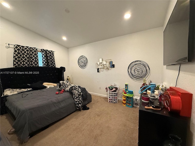 carpeted bedroom with vaulted ceiling