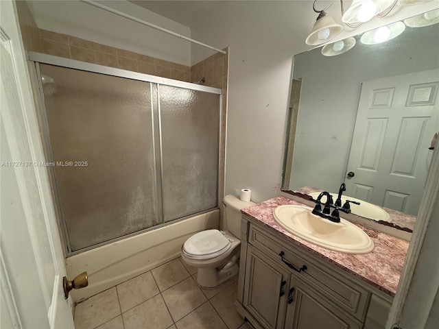 full bathroom featuring toilet, tile patterned flooring, enclosed tub / shower combo, and vanity