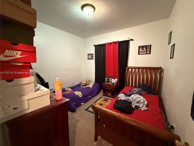 bedroom featuring a textured ceiling and carpet