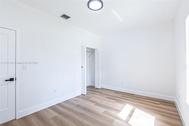 spare room featuring light wood-type flooring