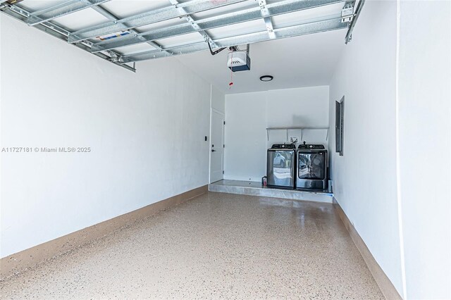 garage featuring a garage door opener and washer and dryer