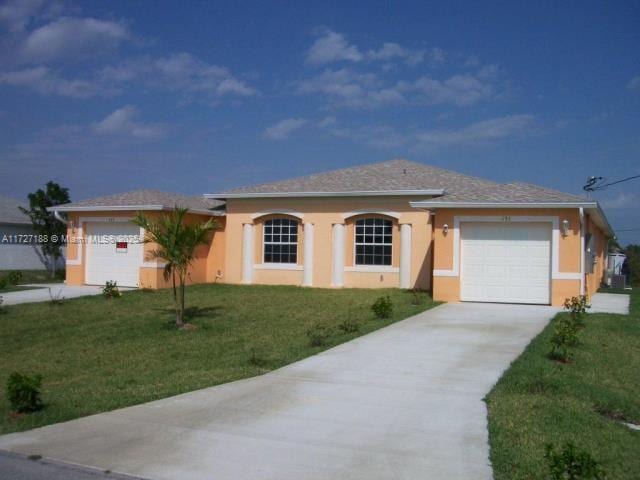 ranch-style house featuring a garage and a front yard