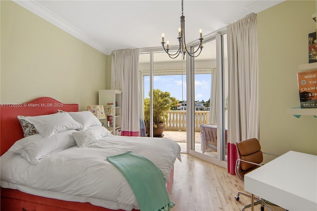 bedroom with an inviting chandelier, crown molding, light hardwood / wood-style flooring, and access to outside