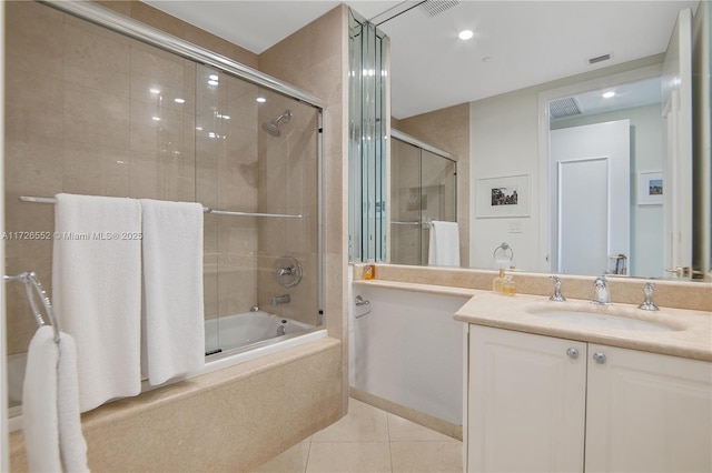 bathroom featuring enclosed tub / shower combo, tile patterned flooring, and vanity