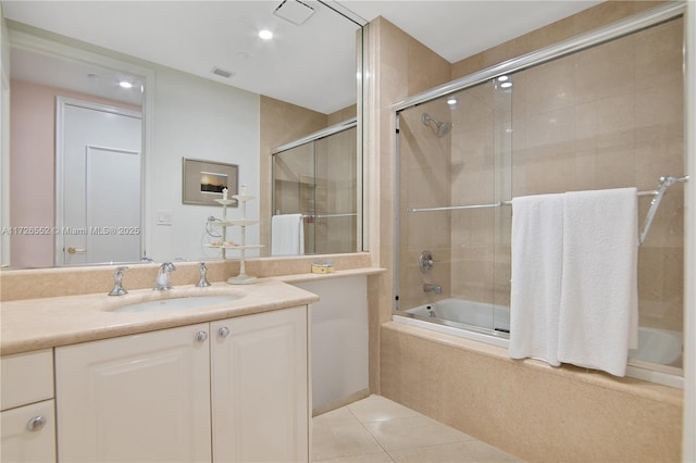 bathroom with tile patterned floors, enclosed tub / shower combo, and vanity