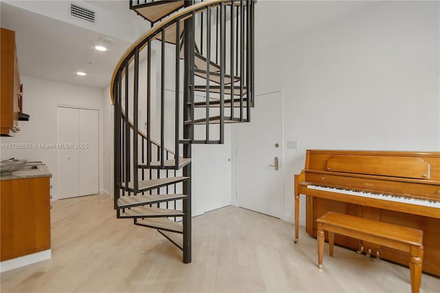 stairs featuring hardwood / wood-style flooring