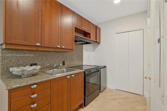 kitchen featuring extractor fan, light stone countertops, black / electric stove, light hardwood / wood-style flooring, and sink